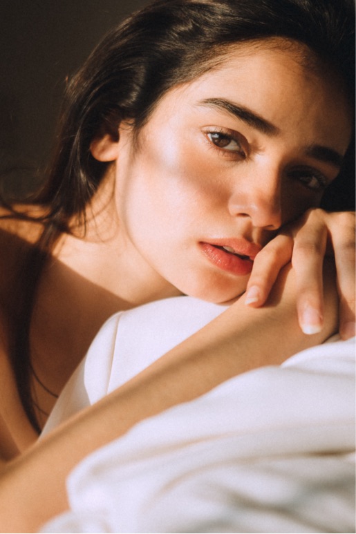 Woman in morning sun looking at camera